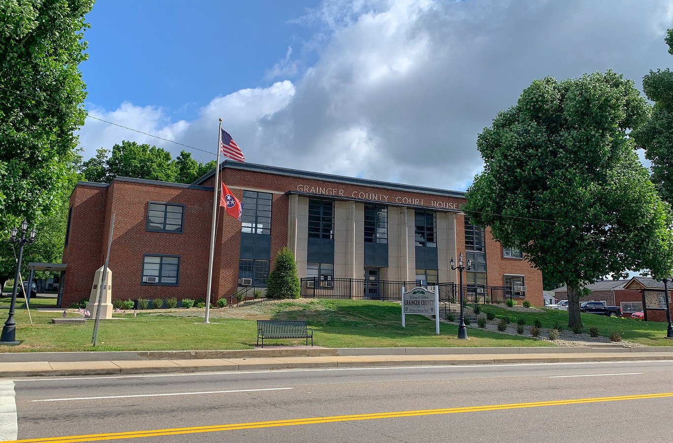 Grainger County Courthouse in Rutledge, TN, a brick courthouse with a flag on the front lawn