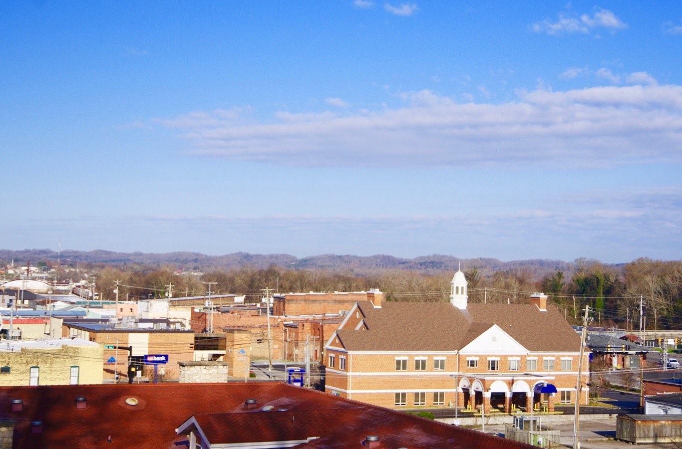 Rooftops and storefronts of downtown Newport, TN, seen from above on a clear day