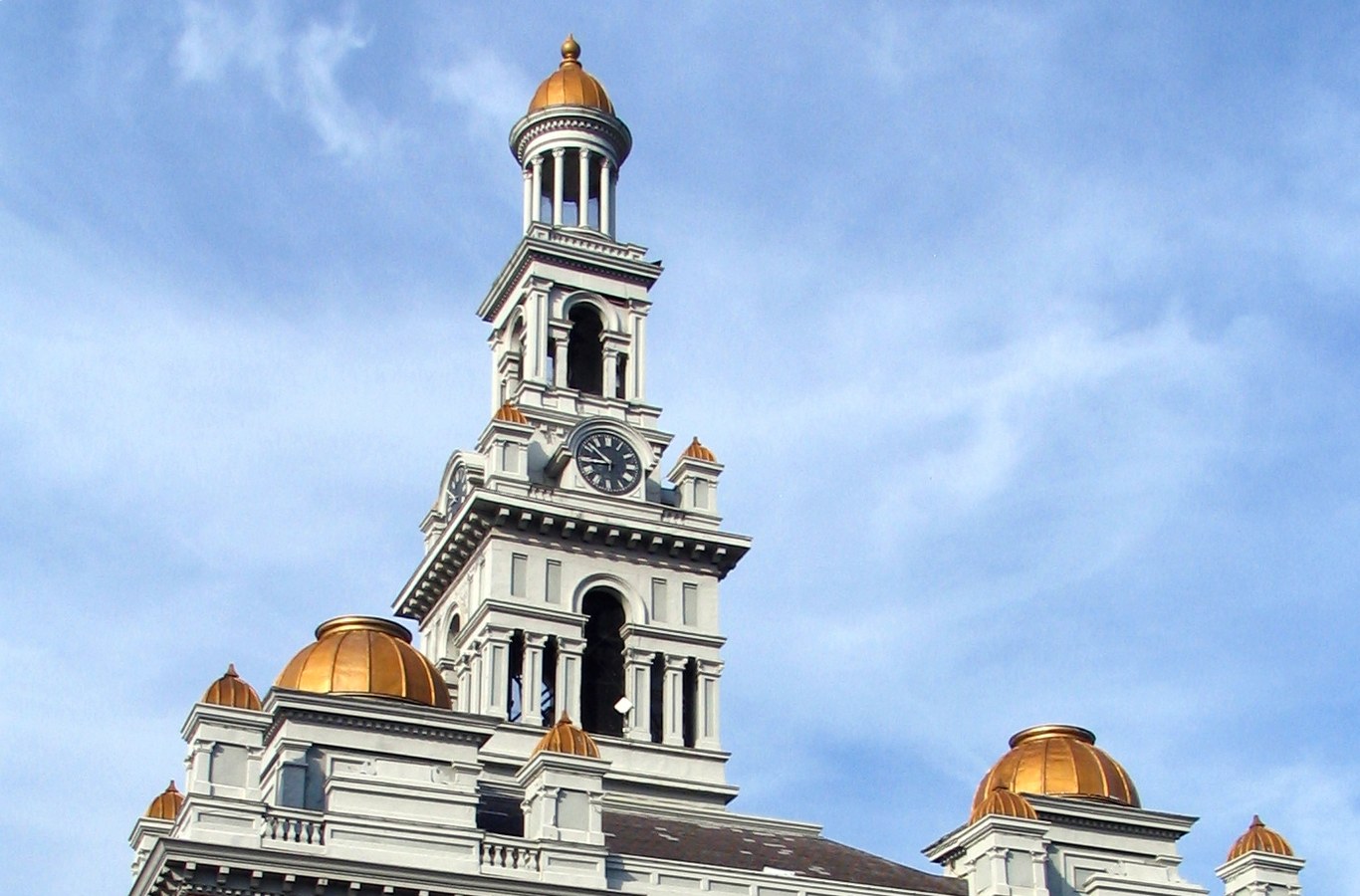 Sevier County Courthouse in Sevierville, TN, with its clock tower and gold domes against a blue sky