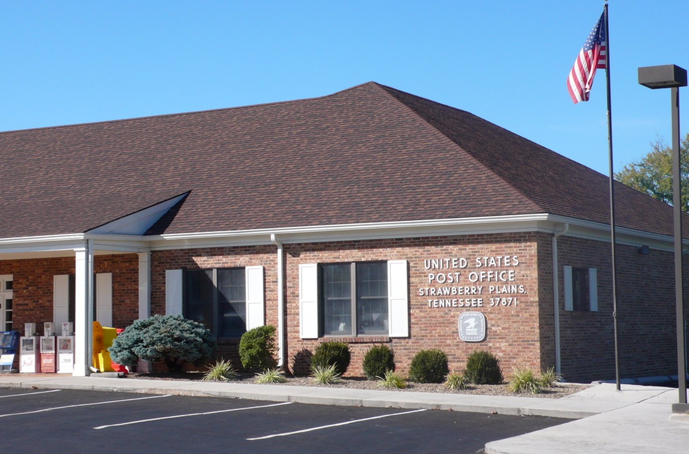 United States Post Office in Strawberry Plains, TN, a brick building with its name above the door
