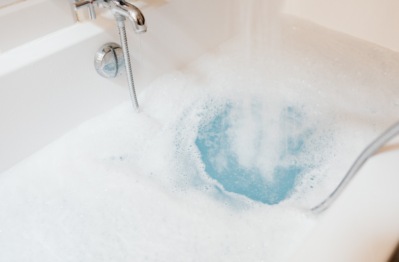 Bubble bath filling from a faucet, kept warm by Starling Plumbing in Newport, TN. Water Heater Services Near Me.