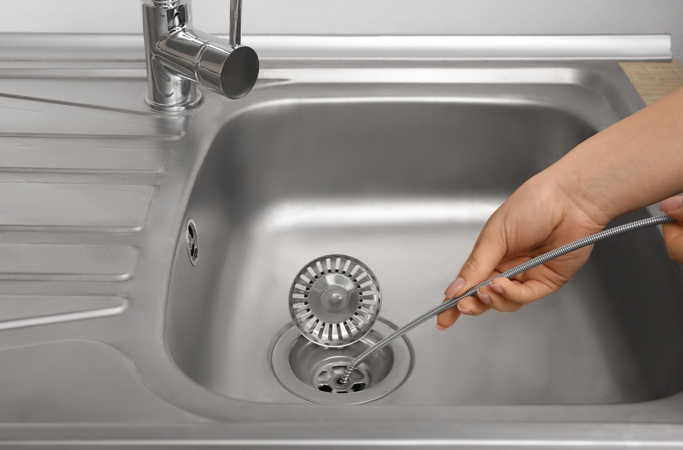 Drain cable clearing a stainless kitchen sink, the kind of backup Starling Plumbing clears in Boyds Creek, TN homes