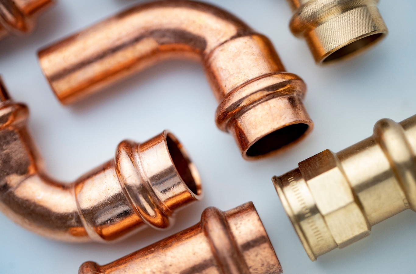 Copper elbows and brass fittings laid out for a job, the parts Starling Plumbing uses on heater lines in Rutledge, TN
