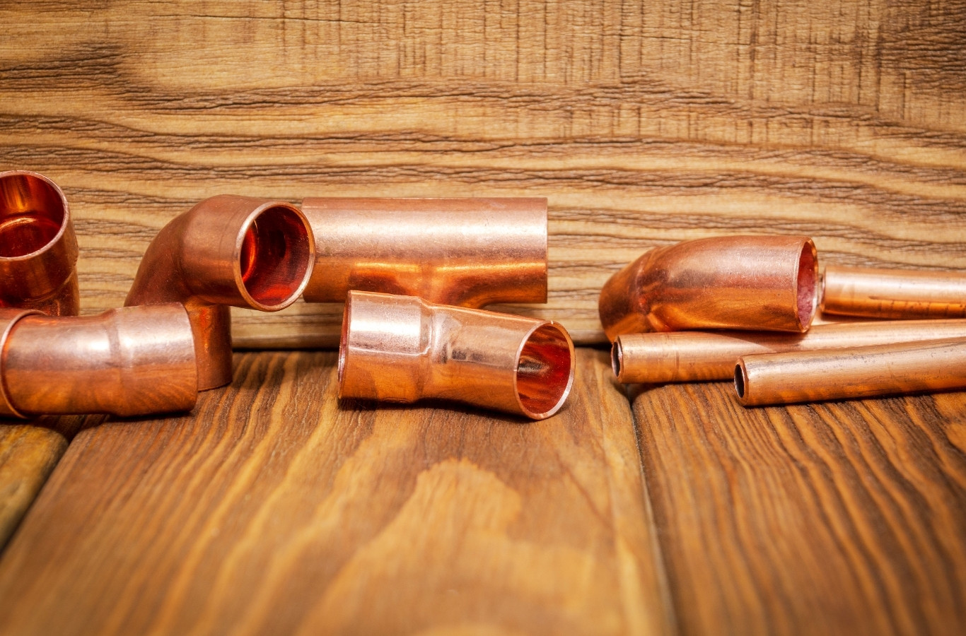 Copper pipe fittings on a bench, parts used by Starling Plumbing in Bean Station, TN. Water Heater Services Near Me.