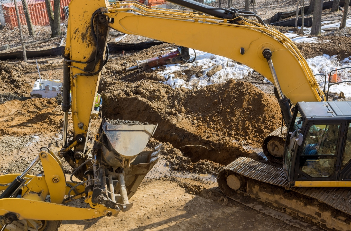 Excavator digging a sewer line trench, work by Starling Plumbing in Morristown, TN. Drain & Sewer Services Near Me.