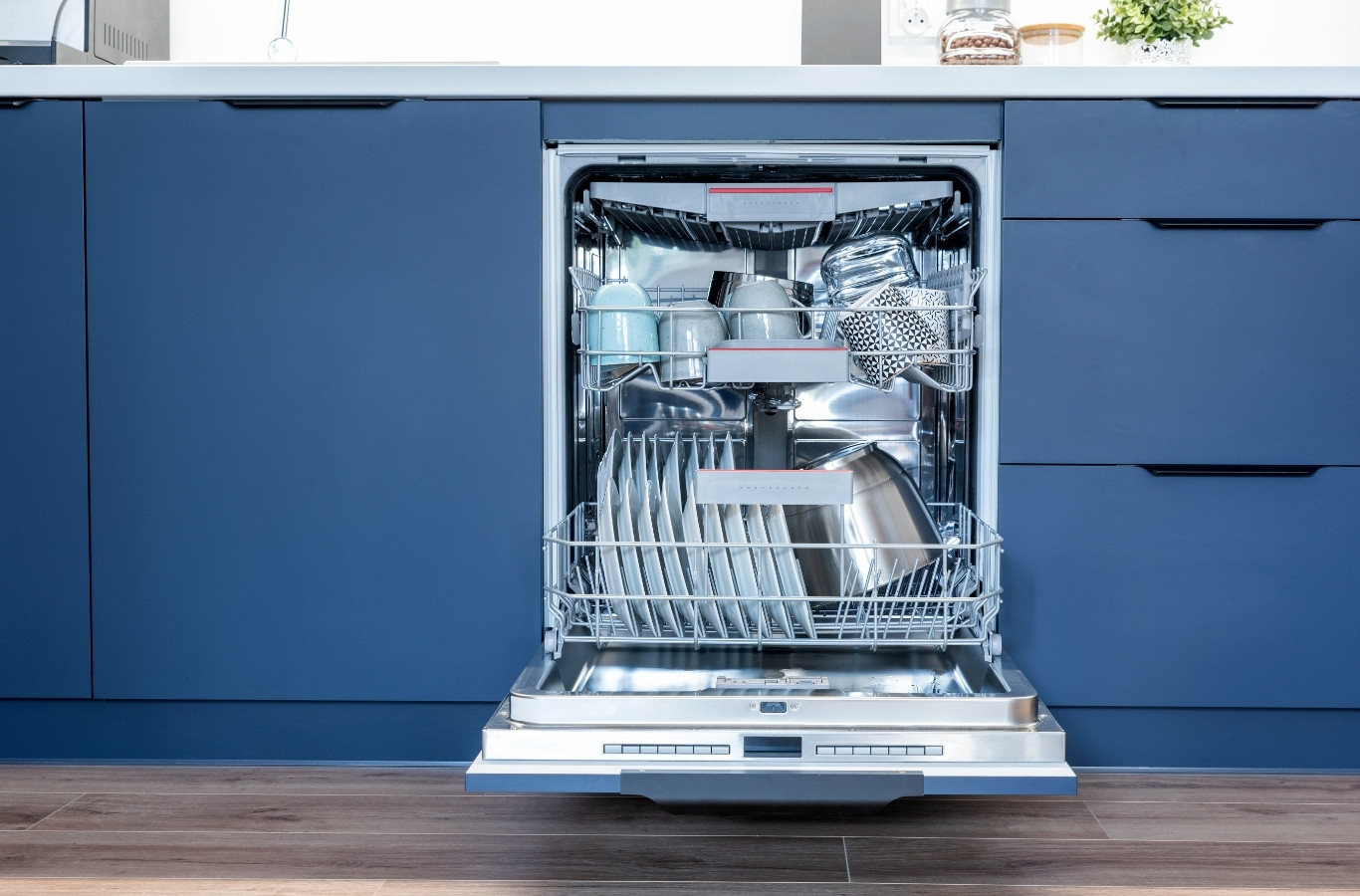 Open dishwasher in a blue kitchen, a load Starling Plumbing plans for in Blaine, TN. Water Heater Services Near Me.