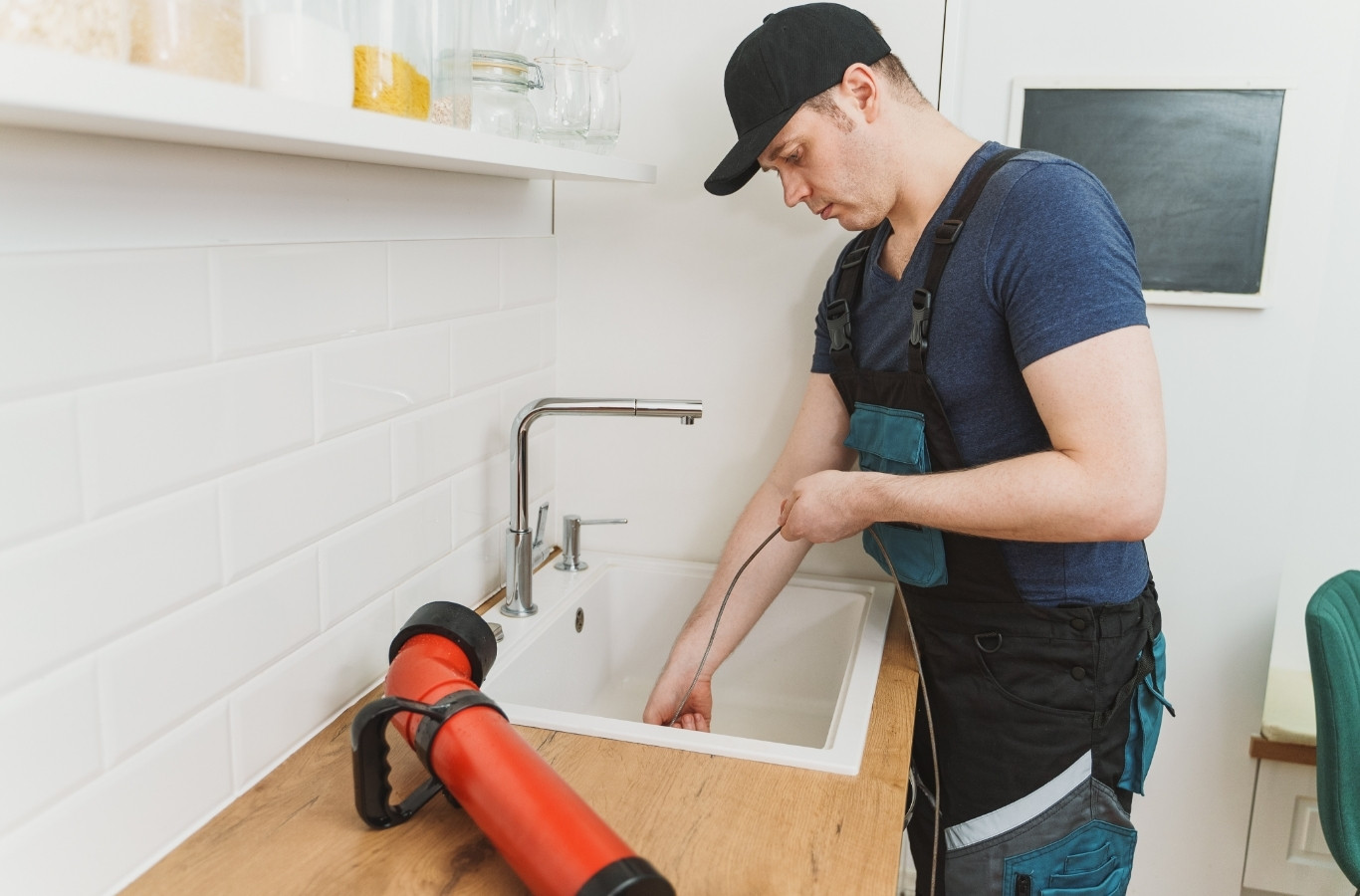 Plumber running a drain cleaning machine into a sink, drain work Starling Plumbing handles in Cocke County, TN