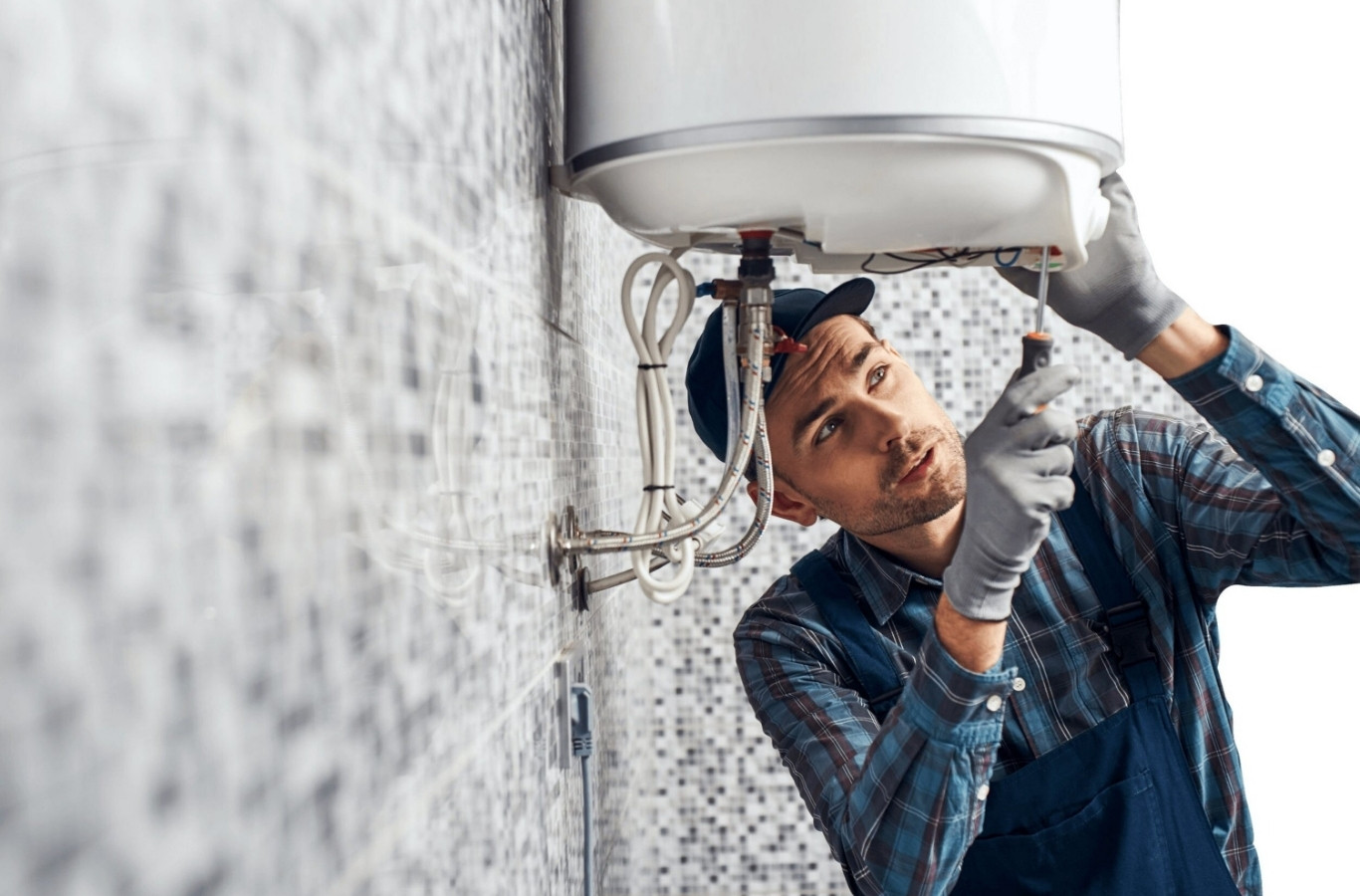 Plumber servicing a wall-mounted water heater, hot water work by Starling Plumbing in Talbott, TN. Plumber Near Me.