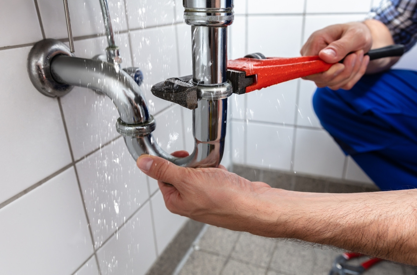 Pipe wrench tightening a chrome sink trap to stop a leak, a repair Starling Plumbing handles in Talbott, TN homes